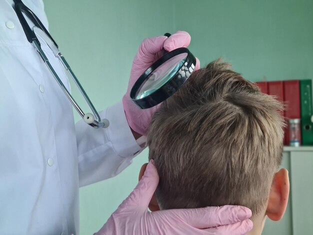 Photo trichologist examines condition of teenage boyhair