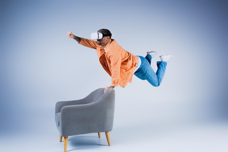 फोटो the trickster man in orange shirt flying near chair