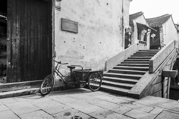 Tricycle and steps against building in town