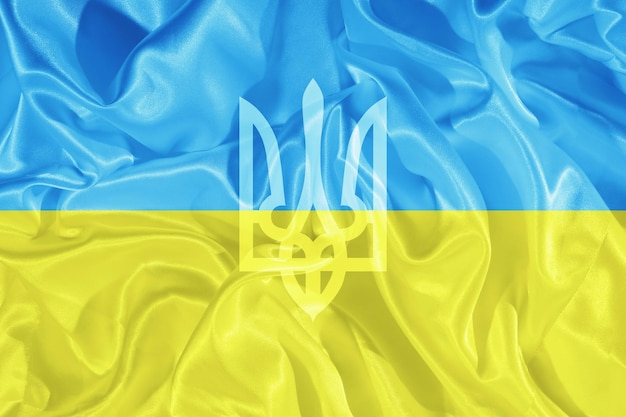 Trident on the background of the yellow and blue flag of Ukraine National symbol of the state of Ukraine