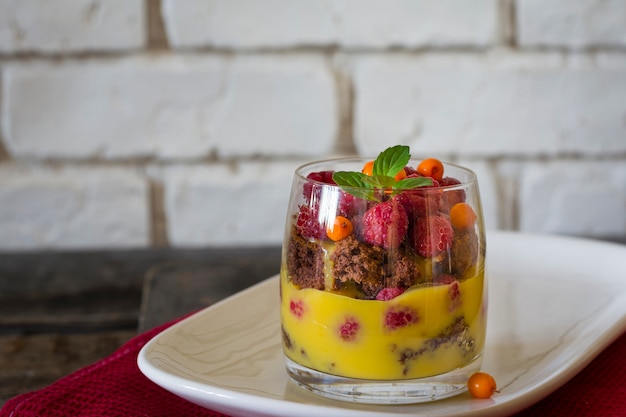 trifle. Dessert in glass. Mousse in glass. Orange curd. Raspberry. Mini cake. Citrus dessert