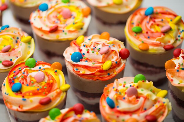 Trifles in plastic glasses on wooden background