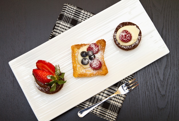 trio of cakes with fruit