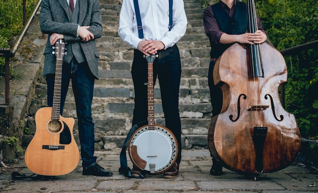 Trio of musicians with a guitar, banjo and contrabass