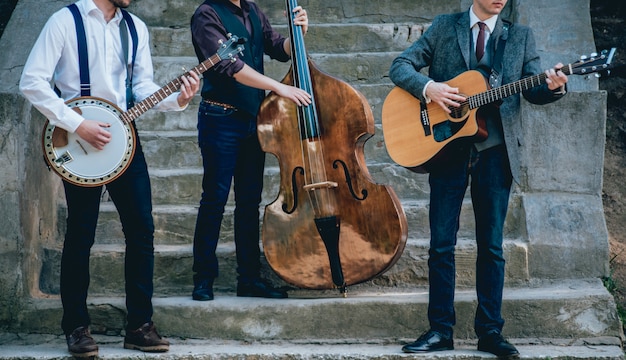 Trio of musicians with a guitar, banjo and contrabass