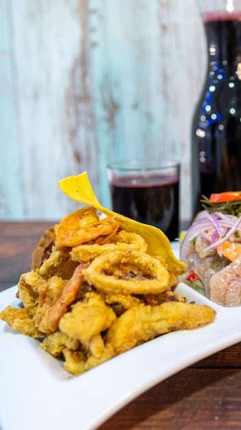 Tris di frutti di mare, chicharrón, ceviche e riso misto.