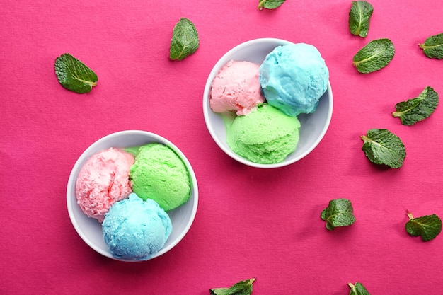 Trio of tasty ice cream in bowls on color background