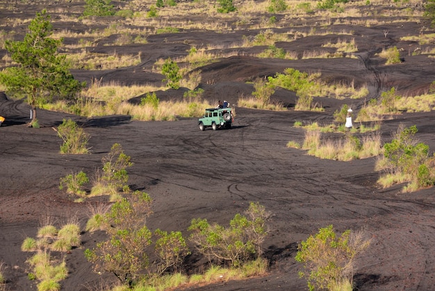 インドネシア・バリ島のバトゥール火山への旅 黒い溶岩砂と緑の植物