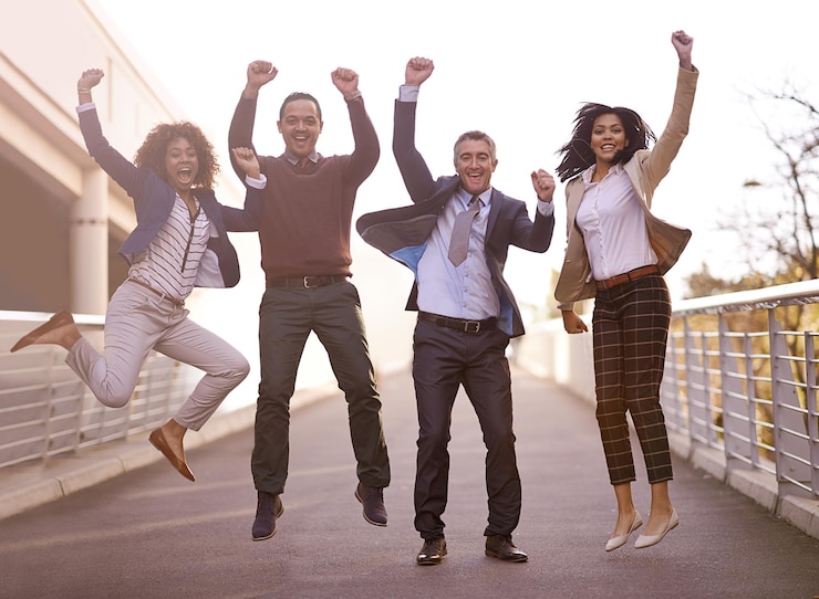Photo the triumphant team a group of businesspeople jumping with excitement outside