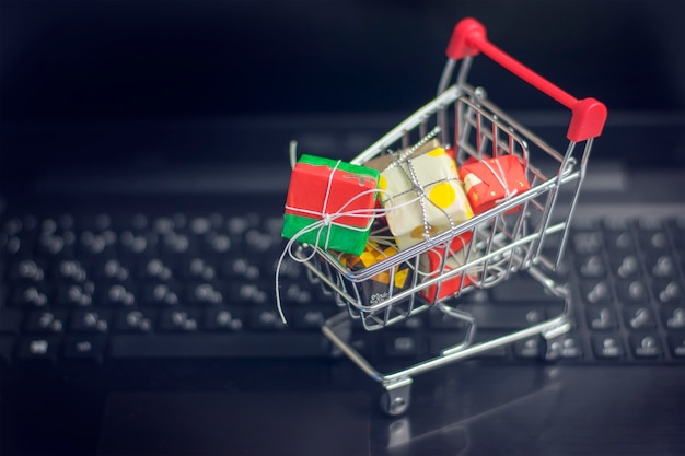 Trolley with gifts on the laptop.