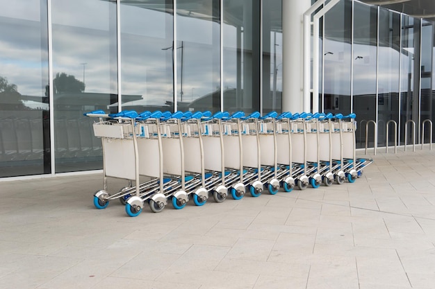 Trolleys luggage in a raw in modern airport