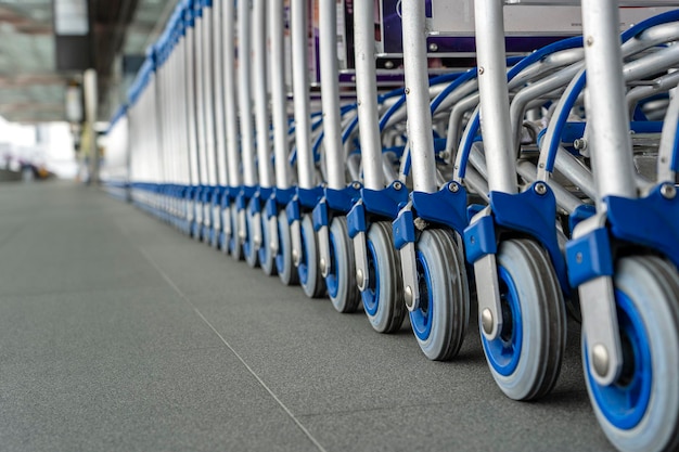 Trolleys luggage in a row in modern airport Close up many of empty luggage carts