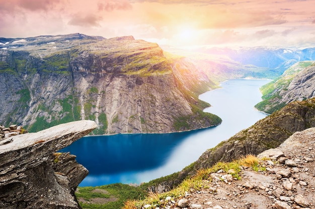 Trolltunga - famous landmark in Norway. Panoramic view of fjord lake and mountains, summer landscape