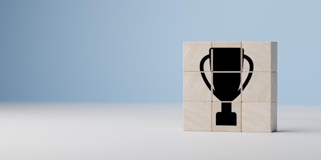 Trophy prize icon on wooden cubes Success and achievement concept Business success and goal achievement concept blue background copy space