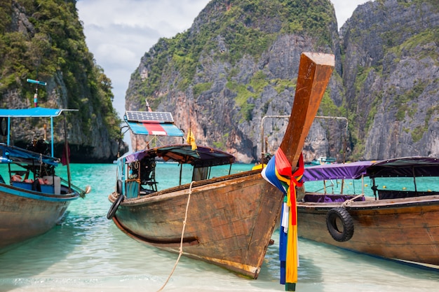 Tropical beach, traditional long tail boats, famous Maya Bay