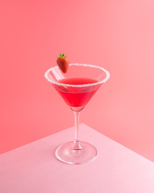Tropical cocktail with strawberry on vivid pink