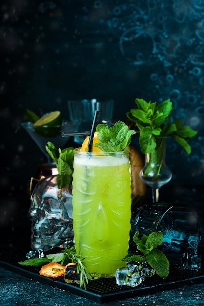 Tropical delicious green alcoholic cocktail  Jungle Juice On a black stone background Menu bar Alcohol