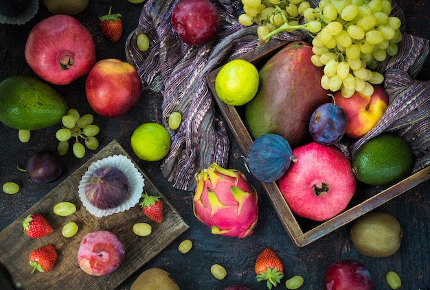 Tropical different fresh fruits. Top view. Black background. 