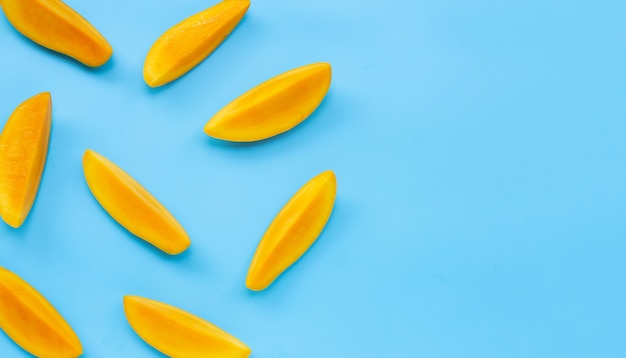 Tropical fruit, Mango slices  on blue background.