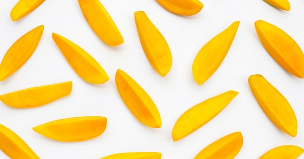 Tropical fruit, Mango slices on white surface.