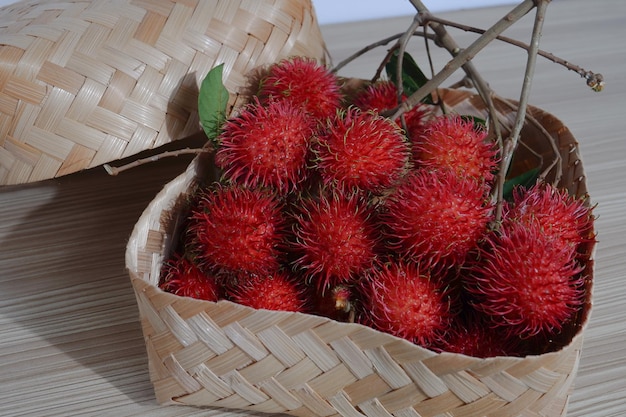 tropical fruit rambutan in a woven bamboo basket