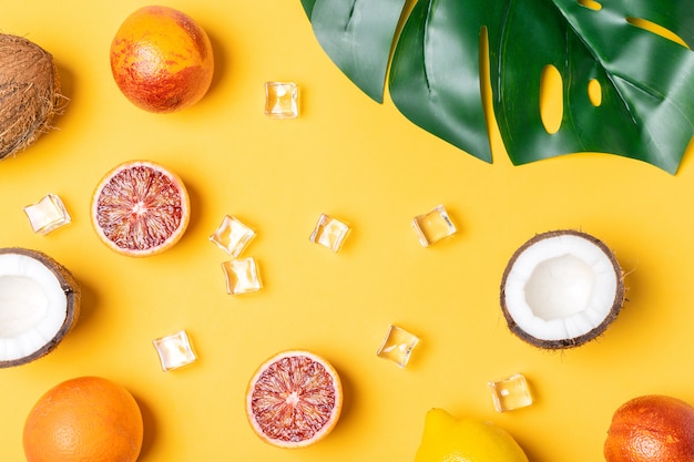 Photo tropical fruits, blood oranges, coconut, palm leaf