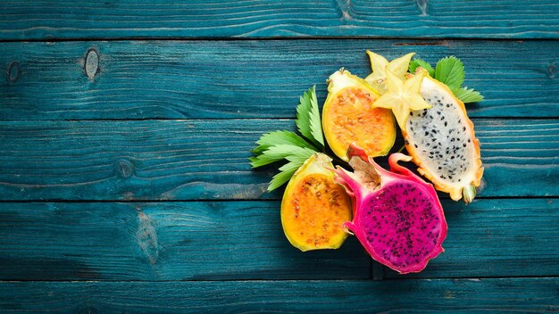 Tropical Fruits - Cactus and dragon fruit on a wooden background. Top view. Free space for text.