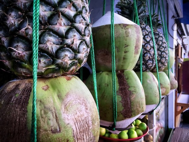 Tropical Fruits Hanging in Front of Beverage Juice Store