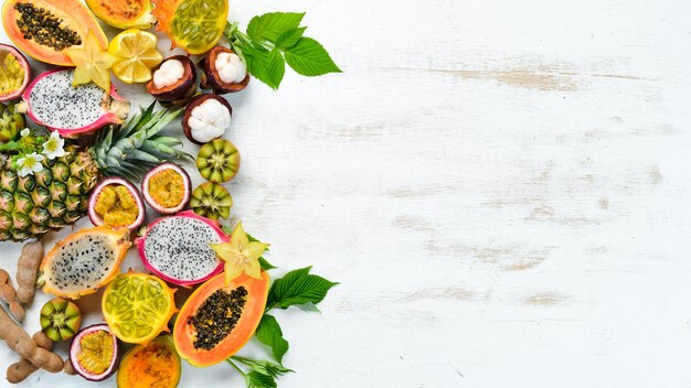 Tropical fruits on a white background papaya mangosteen cactus fruit pytahaya pineapple Top view Free space for text