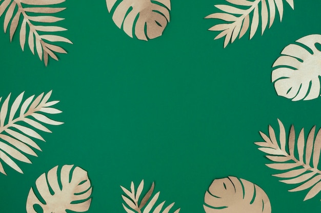 Tropical gold paper leaves on green