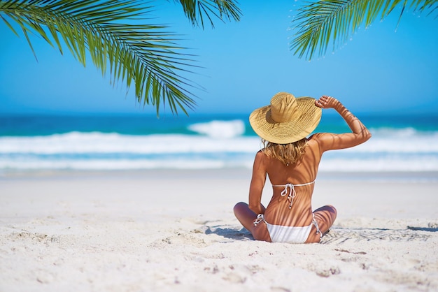 Tropical island beach and back of woman for summer adventure holiday and vacation in Mauritius Travel mockup ocean and female person relax in bikini on sand for tourism traveling and getaway