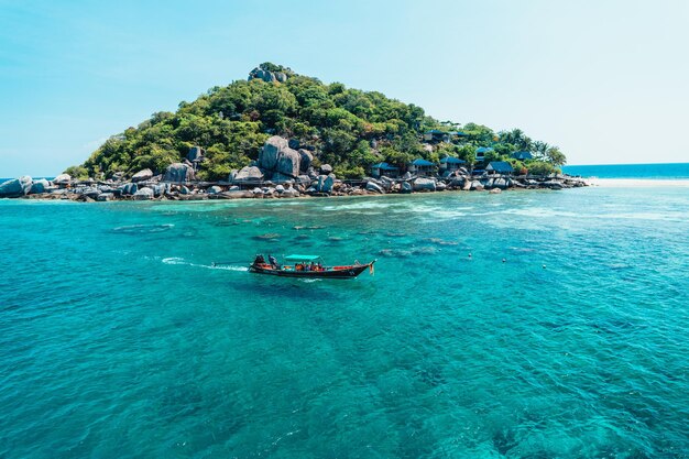 Tropical island and longtail boat