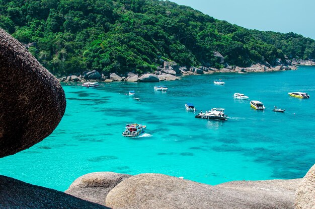 Tropical islands of ocean blue sea water and white sand beach at Similan Islands with famous Sail Rock Phang Nga Thailand nature landscape