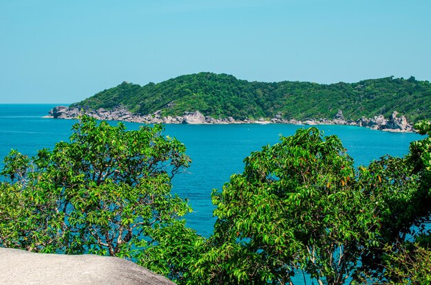 Tropical islands of ocean blue sea water and white sand beach at Similan Islands with famous Sail Rock Phang Nga Thailand nature landscape