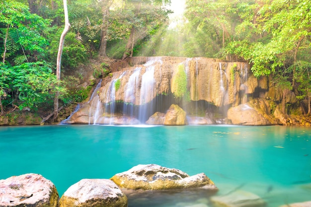 Tropical landscape with beautiful waterfall emerald lake and green tree in wild jungle forest Erawan National park Kanchanaburi Thailand