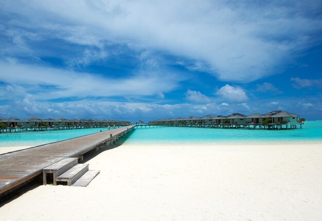 Tropical Maldives island with white sandy beach and sea