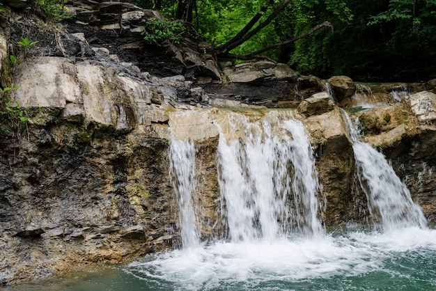 Tropical nature. Beautiful tropical waterfall surrounded with trees