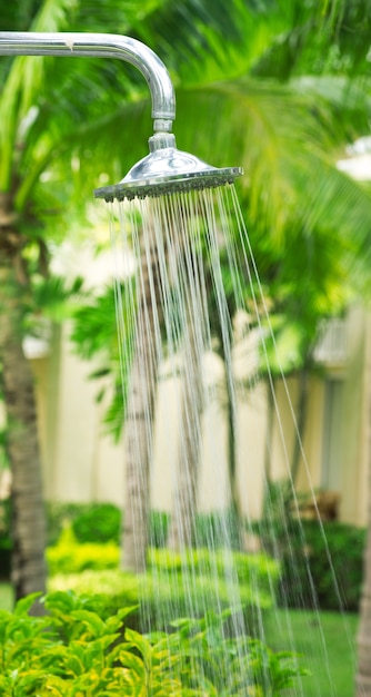 Tropical refreshing shower under palm trees