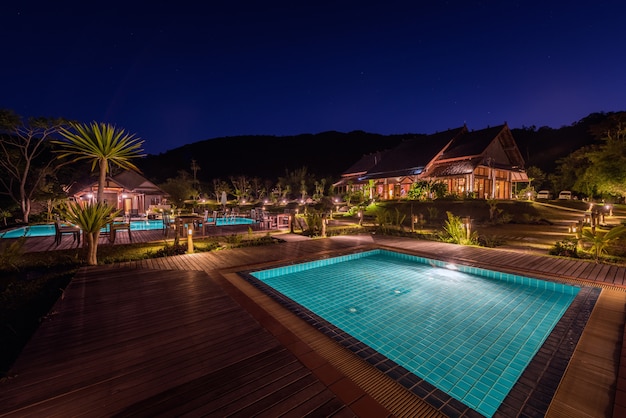 Tropical resort with swimming pool at night