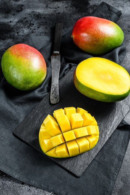 Tropical ripe mango fruit. Black background.