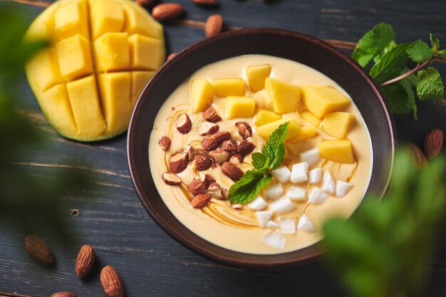 Tropical smoothie bowl with banana mango coconut and nuts