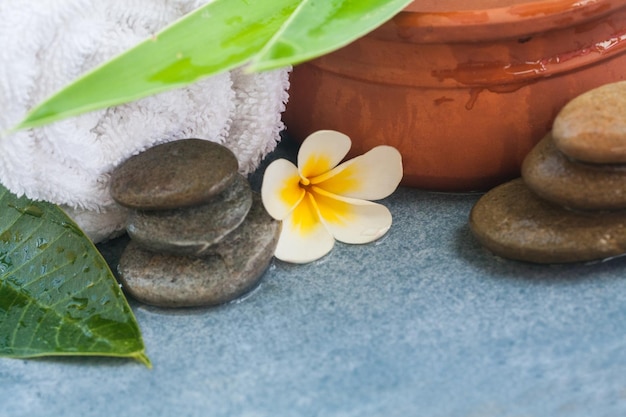 Tropical spa objects for massage with sunlight on blue table background