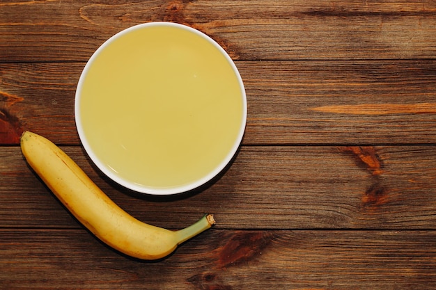 Tropical yellow jelly with banana in a plate on the table