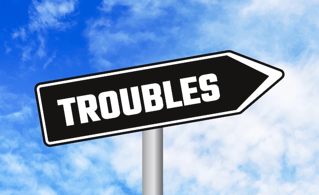 Troubles road sign on blue sky background