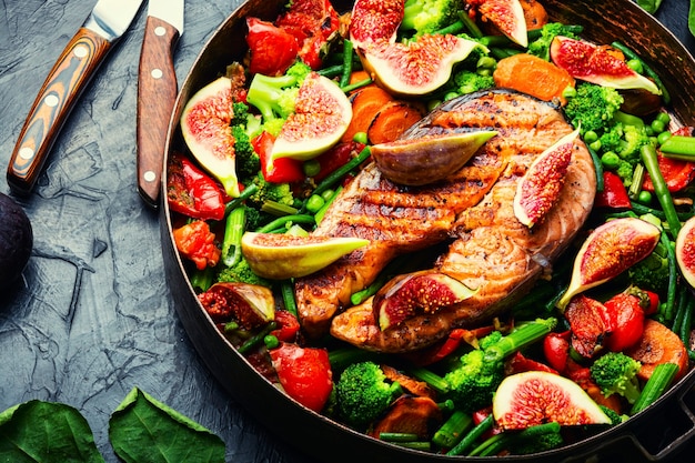 Trout steak fried with vegetables.