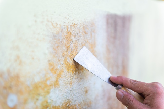 Trowel cleaning the surface of a wall