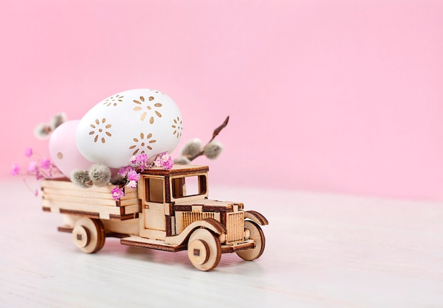 truck carrying easter eggs on pink background