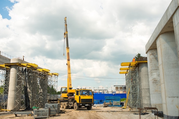 Truck crane at a construction site during the construction of a transport bridge