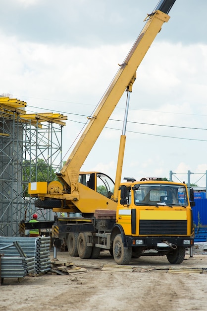 Truck crane lifts a load at a construction site