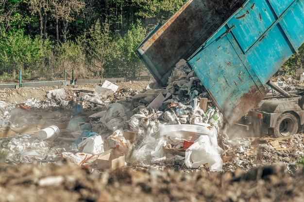 The truck dumps mixed waste at the landfill. waste storage,\
ecological solutions